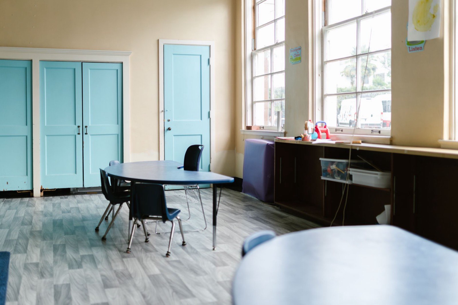 People gathered around tables in a community room