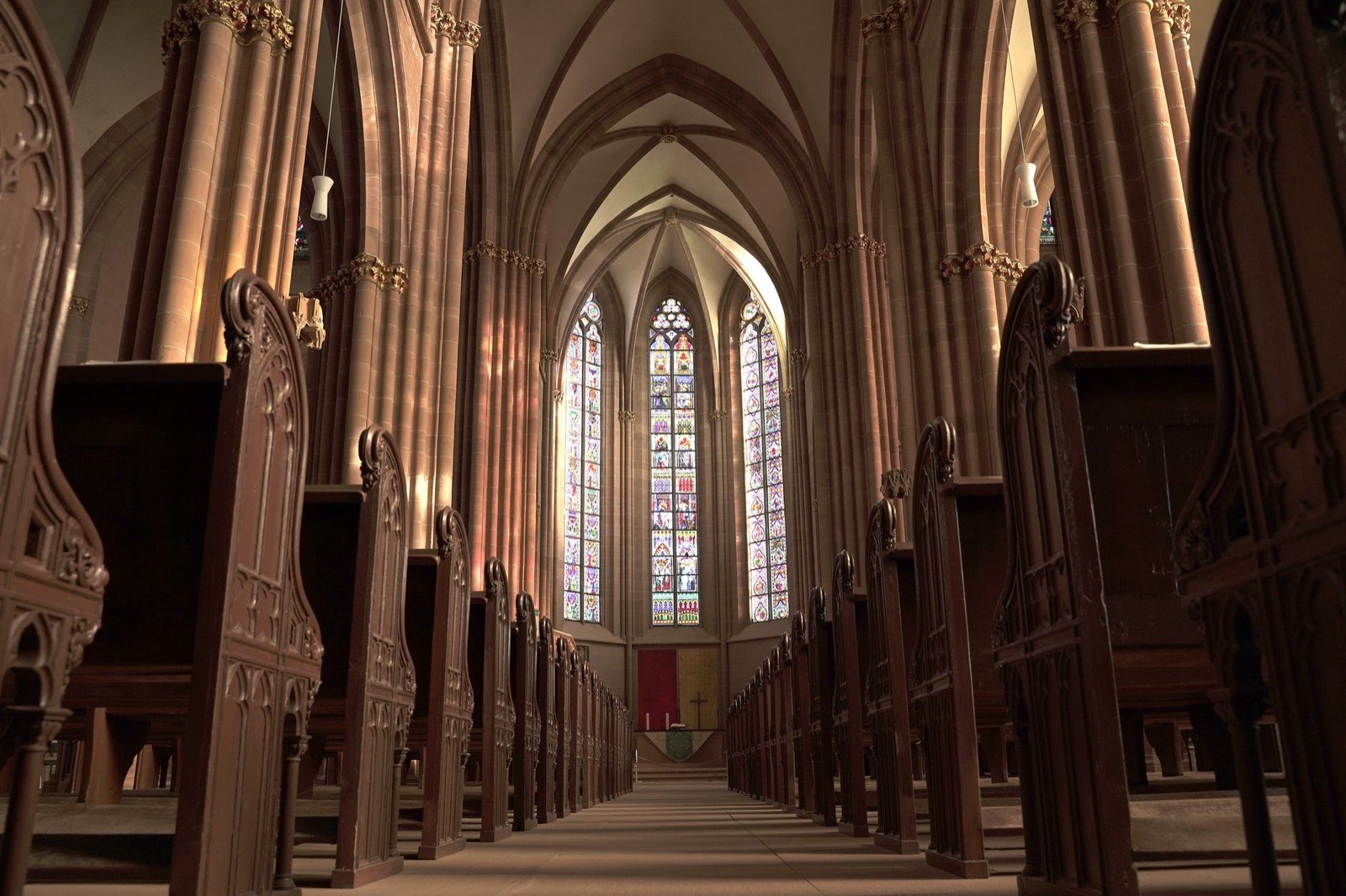The interior of a church sanctuary with stained glass windows